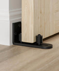 Sliding Barn Door Bottom Floor Guide with Wall Mounted Rollers, Adjustable Stay Roller and Ball Bearings, flat bottom design, black finish, heavy duty steel construction for smooth, quiet door operation.