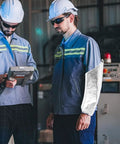 Heavy Duty Heat Resistant Aluminum Foil Arm Sleeves, Waterproof Cut Resistant Forearm Guards Shop Tough Armor For Welders Mechanics And Garage Grinders, 2 Pack worn by a worker in safety gear.