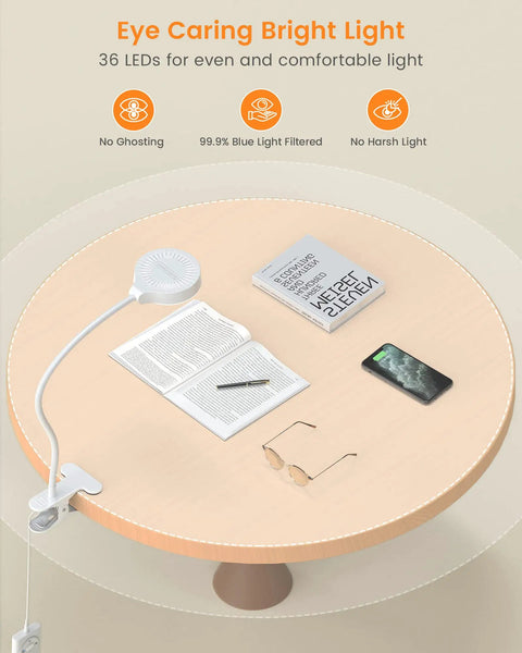 Clip On LED Reading Light for Bed with 36 LEDs illuminating books and phone on a wooden table, showing eye caring light features.