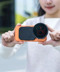 Person holding 67mm Magnetic Double Sided Phone Lens Filter Adapter Mount With Cold Shoe for iPhone in use outdoors
