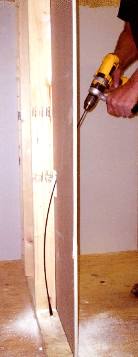 Person drilling drywall with Installer Drill Bit One Half Inch By Thirty Six Inch, Heavy Duty High Speed, Split Point, USA made
