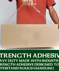 Person holding box with Heavy Duty Clear Packing Tape For Shipping And Moving, 12 Rolls Of Thick, Super Sticky Sealing Tape, 1.88 Inch Wide