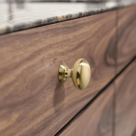 Close-up of a cabinet with a champagne bronze knob, part of 10 Pack Cabinet Knobs In Champagne Bronze Heavy Duty Zinc Alloy Hardware Handles For Kitchen Cabinets Bedrooms Dressers And Wardrobes Easy Install Durable Finish Classic Look For Any Home.