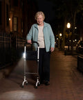 Elderly woman outdoors at night using Stand Assist Rail for Elderly and Seniors, Quad Cane Mobility Aid With Four Point Support