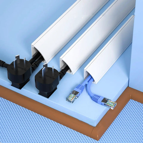Game Changer Self Adhesive Cable Hider For Zero Mess Walls Smooth PVC Cord Cover installed along baseboards with cables hidden.
