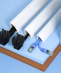 No Sweat Self Adhesive Cable Hider Wall Strips Heavy Duty Pvc Raceway with electrical and Ethernet wires neatly tucked in.