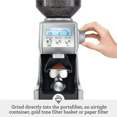 Hand adjusting grind settings on Smart Grinder Pro Coffee Grinder With 60 Settings For Espresso And Brew Dope Dose Control Digital Timer.