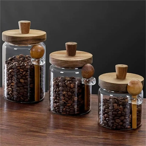 Go Ahead And Upgrade Your Countertop Setup With This Solid Clear Glass Storage Jar Featuring An Airtight Sealed Kitchen Canister And Wooden Spoon For Coffee Beans 900Ml Capacity on wooden table.