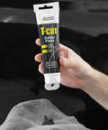 Hand holding Color Fast Scratch Remover for Black Car Paint 5.3 Oz, Fix Scratches, Mask Oxidation, and Bring Back Showroom Shine