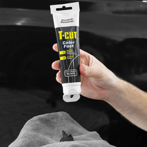 Hand holding Color Fast Scratch Remover for Black Car Paint 5.3 Oz, Fix Scratches, Mask Oxidation, and Bring Back Showroom Shine