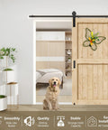 Installed sliding barn door with black I shape hangers and a flower decoration, showing heavy-duty hardware kit for 1 3/8 to 1 3/4 in doors.