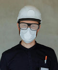 Man wearing Heavy Duty Welding Safety Glasses Featuring Over Glasses Compatible Design with hard hat and mask, providing eye protection.
