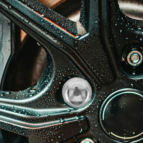 Close-up of wheel with wet surface, showcasing Heavy Duty Wheel Hub Flange Bolts Nuts For ATV And Go Kart.