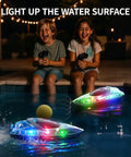 Two children playing with Twin Pack Remote Control Boats For Kids And Adults With Dual Speed Modes in a pool at night.