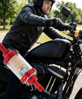 Motorcyclist with Five Sixteenth Inch Beefy Inline Gas Filter With Reusable Aluminum Body And Clear Glass attached to the bike.