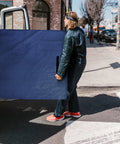 Person carrying a waterproof mattress bag for moving and storage, queen size 82 inch by 63 inch by 15 inch, with strong handles