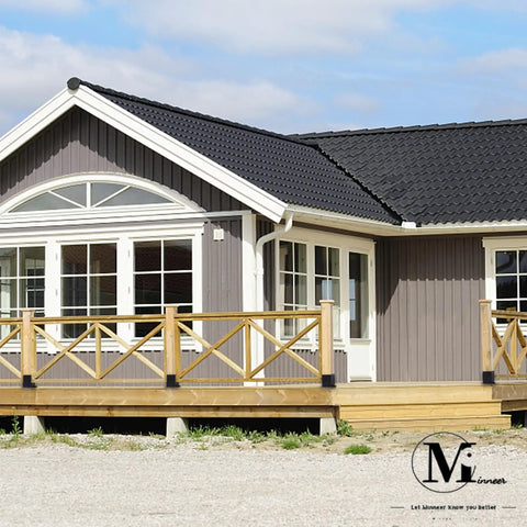 Grey wooden house with a black tiled roof and wide porch, showcasing potential use of 8 Pack 6x6 Post Bases Real Size 5.5x5.5 Black.