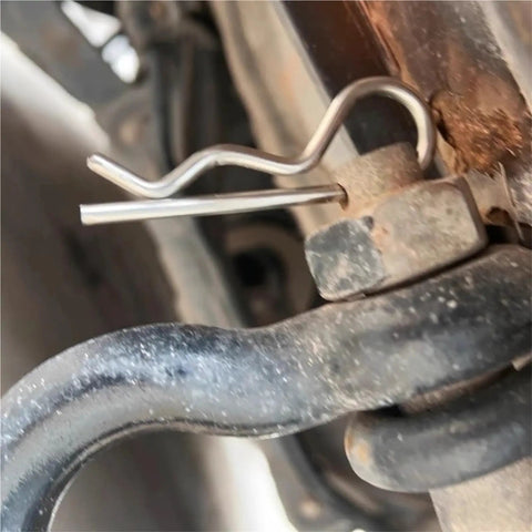 Close-up of R Clip Hairpin Style Cotter Pin securing metal components on trailer hitch, heavy-duty steel wave shape clip