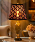 Stylish table lamp with decorative shade on a round table in a cozy living room setting