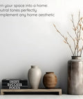Monochrome Faux Book Decor Set Of 3 For Modern Desk And Shelf Vibe next to neutral vases and twigs on a minimalist shelf