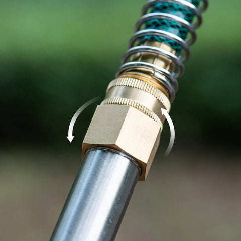 Brass Garden Hose Adapter 3/4 GHT Female To 3/4 NPT Female Swivel Connector attached to hose and pipe fitting