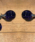 Set of 12 blue crystal pumpkin knobs for cabinets on wood surface, cast iron hardware, vintage style for home decor upgrade.