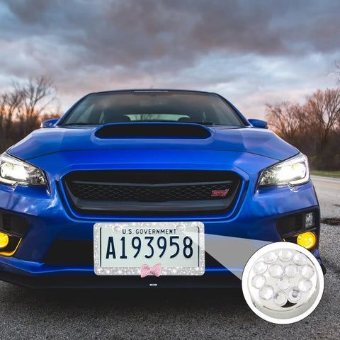 Blue car with front license plate highlighted, showing Anti Rattle Stainless Steel License Plate Screw Caps With Rhinestone Diamond Accents Black 4 Pack Rustproof Keeps Your Front And Rear Plates Secure And Quiet While Driving.