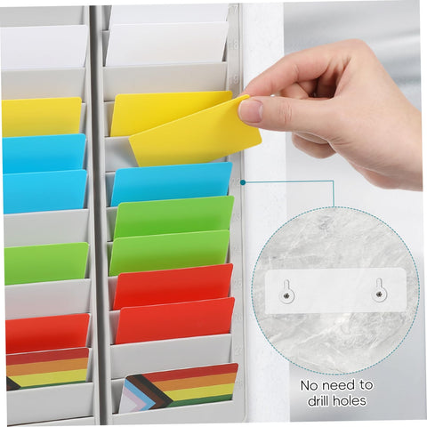 Hand inserting a yellow card into Heavy Duty 28 Slot Guest Room Key And Badge Organizer Rack for easy access.