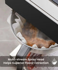 Close-up of 12 Cup Commercial Drip Pour Over Coffee Maker with Two Glass Carafes brewing coffee, multi-stream spray head visible.