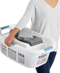 Person carrying XL Hip Hugger Laundry Basket 2.1 Bushel White With Royal Blue Handles For Easy One Hand Carry Laundry Storage