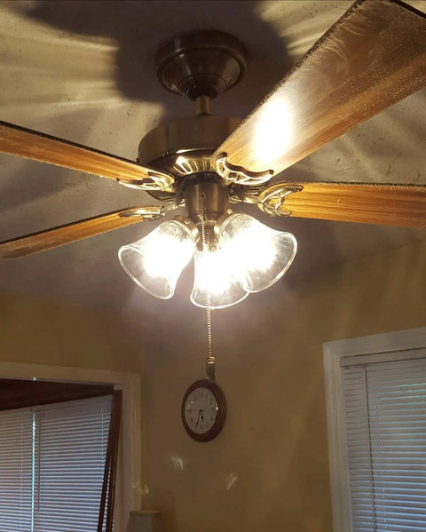 Hammered Glass Bell Shade Set for Ceiling Fans and Light Fixtures, fitted on a ceiling fan displaying illuminated glass covers.