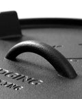 Close-up of the handle on the lid of a Pre Seasoned Cast Iron Camping Dutch Oven 6 Quart With Lid And Tripod Stand For Outdoor Cooking