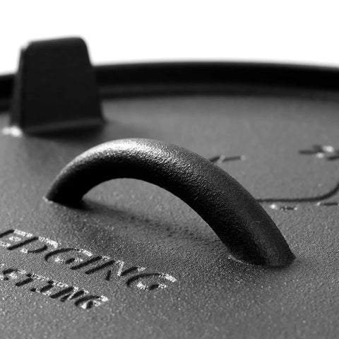 Close-up of the handle on the lid of a Pre Seasoned Cast Iron Camping Dutch Oven 6 Quart With Lid And Tripod Stand For Outdoor Cooking