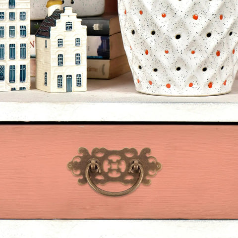 Two Pack Vintage Brass Drawer Pulls Handles for Dressers and Wardrobes on pink drawer with decorative items