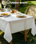 No Sweat Heavy Duty Disposable Tablecloths White 8 Pack 54 By 108 Inches on outdoor table with food and drinks.