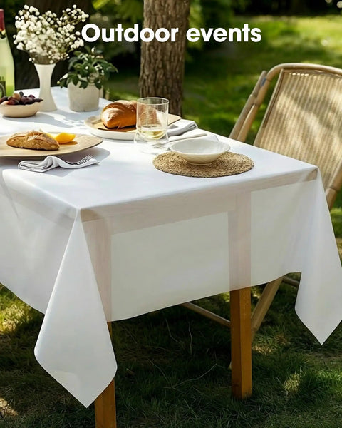 No Sweat Heavy Duty Disposable Tablecloths White 8 Pack 54 By 108 Inches on outdoor table with food and drinks.