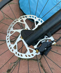 Beefy 180mm Six Bolt Bike Disc Brake Rotor for Road and Mountain Bikes 2.3mm Thick SUS410 Stainless Steel mounted on wheel