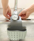 Double Deck Faucet Mount Kitchen Sink Organizer With Adjustable TPR Rubber Sponge Soap And Scrubber Storage Basket, gray, attached to sink.