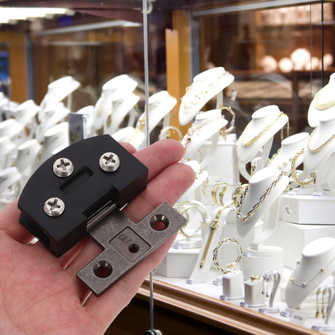 Heavy Duty Stainless Steel Glass Door Hinge For Tempered Glass Doors With Smooth Operation held in hand near jewelry display