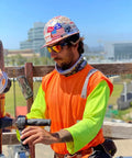 Construction worker wearing Tiger Safety Sunglasses With Dope Matte Black Frame And Red Mirror Lens ANSI Z87 Plus Certified
