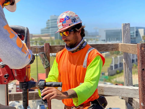 Construction worker wearing Tiger Safety Sunglasses With Dope Matte Black Frame And Red Mirror Lens ANSI Z87 Plus Certified