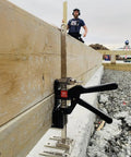 Viking Arm handheld jack/clamp installed on wooden beam at construction site.