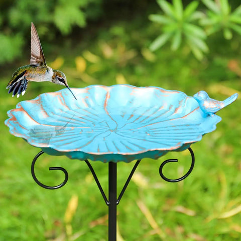 34 Inch Tall Metal Bird Bath On A Stake For Outdoors with a turquoise base, viewed with a hummingbird, in a garden setting.