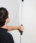 Dust Free Vacuum Sander For Drywall With Pro Pole Sander in use on wall, lightweight aluminum and stainless steel build.
