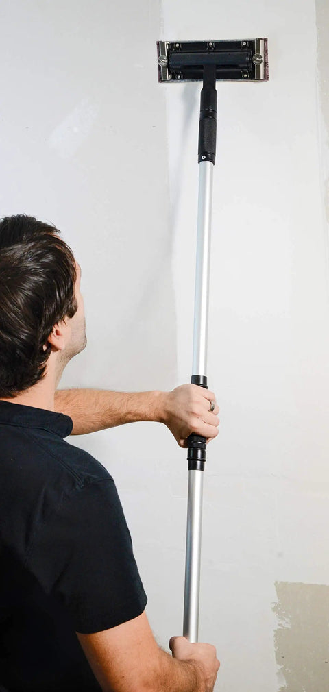 Dust Free Vacuum Sander For Drywall With Pro Pole Sander in use on wall, lightweight aluminum and stainless steel build.