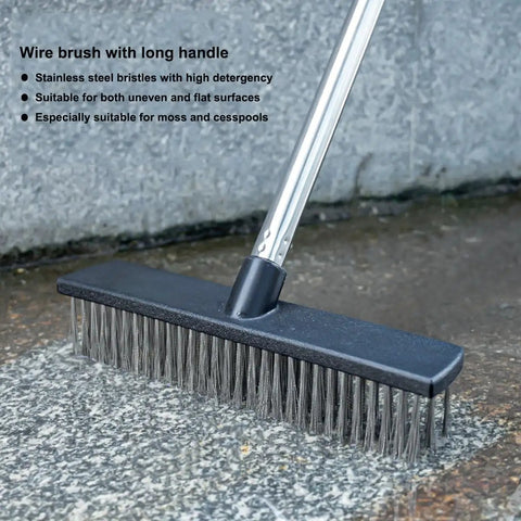 Heavy Duty Push Broom Brush With Tough Stainless Steel Bristles And Solid Handle For Patio Driveway Concrete Deck And Tile Floors Hard As Nails Cleaner close-up shot of wire brush with long handle on concrete surface