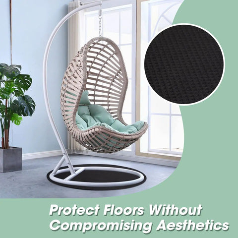 Round Rubber Floor Pad For Recliners, Non Slip Floor Protector Mat with black surface shown under hanging chair indoors.