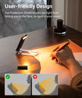 Amber Glow Clip On Book Light With 1800K Eye Care LED USB on desk illuminating paper with user writing
