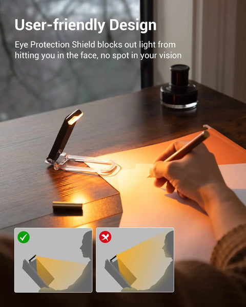 Amber Glow Clip On Book Light With 1800K Eye Care LED USB on desk illuminating paper with user writing