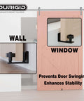 Image of 2 Pack Barn Door Floor Guides With Felt Strips For Quiet Smooth Operation Bottom Roller Guides For Flush Mounted Doors Durable POM Nylon Rollers For Ultra Wear Resistance Anti Noise And Touch 8 Roller Configurations Includes Expansion Bolts Black installed on a wooden sliding door.